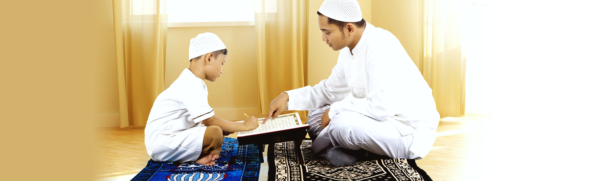 Young father teaching Quran to his son